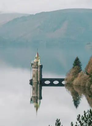 a castle sits on top of a lake