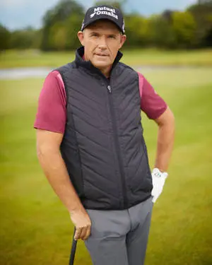  Caption: Three-Time Major Champion Padraig Harrington Leaning on his Golf Club. 